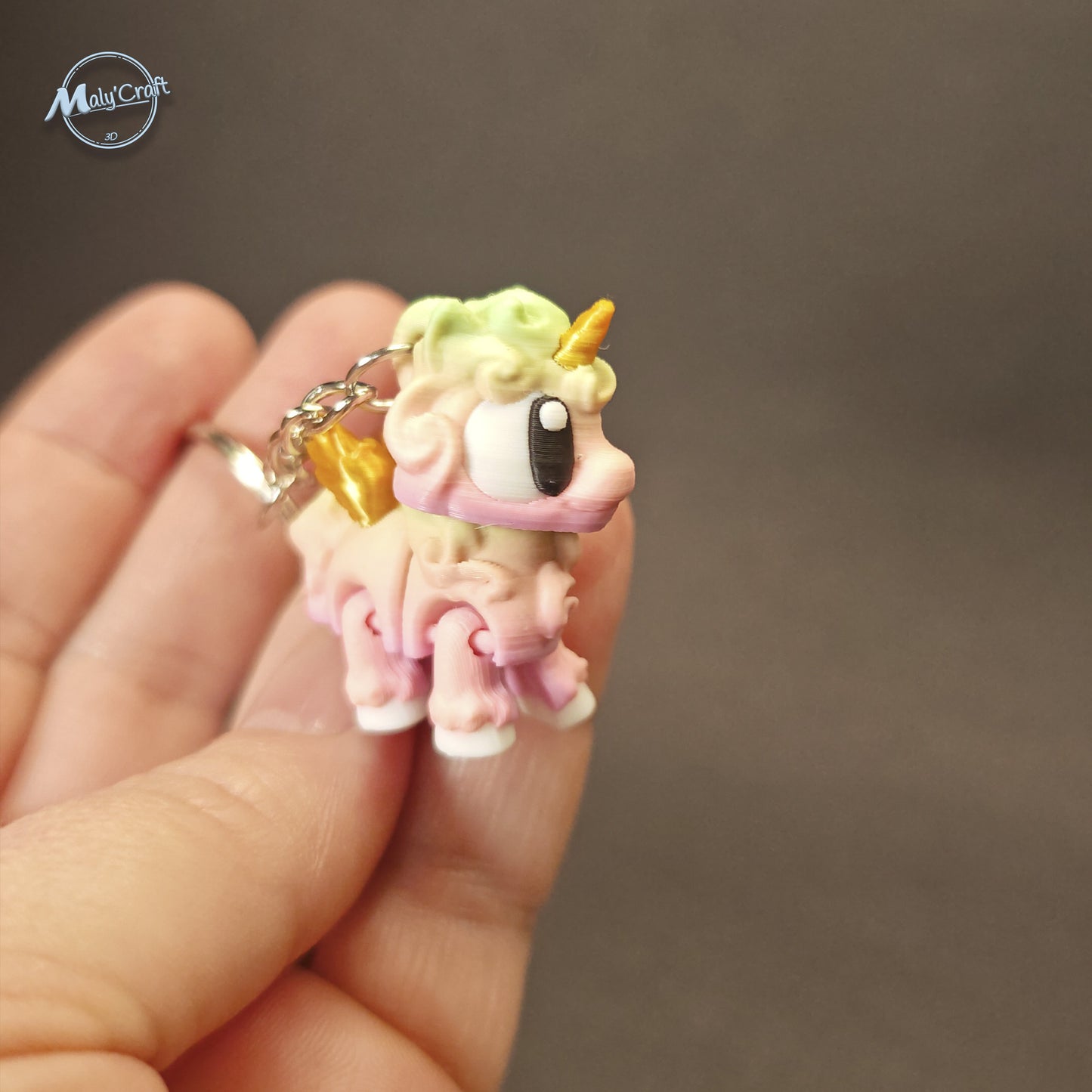 Bijou de sac licorne articulée aux couleurs pastel arc-en-ciel, modèle officiel 3DGob imprimé en 3D de précision.