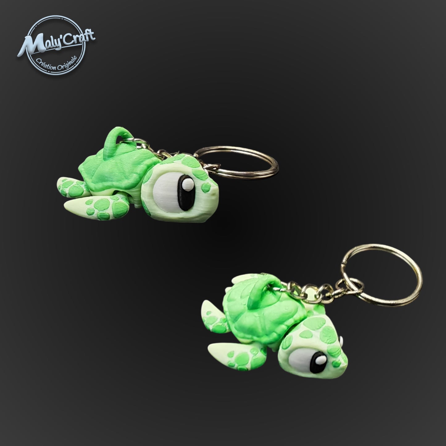 Deux porte-clés tortues de mer vert pomme avec de grands yeux expressifs, réalisés en impression 3D de précision.